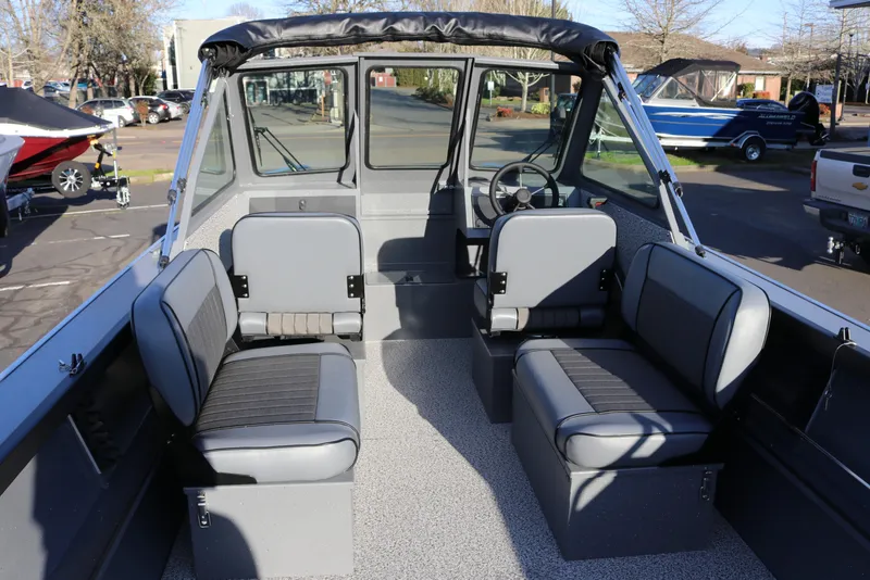 Slide: The Image of 2026 Alumaweld Stryker 220 boat interior with gray seating and steering wheel. - 8