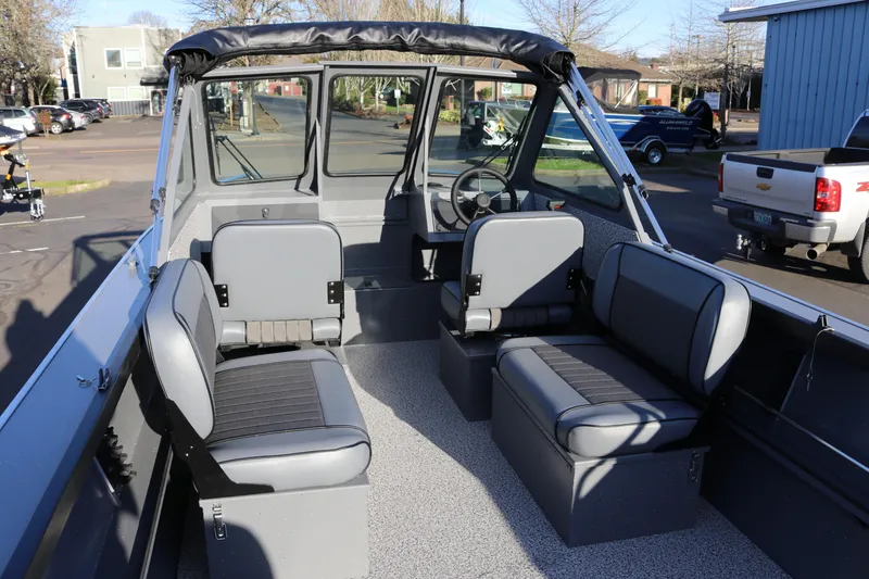 Slide: The Image of 2026 Alumaweld Stryker 220 boat interior with gray seating and steering wheel. - 9