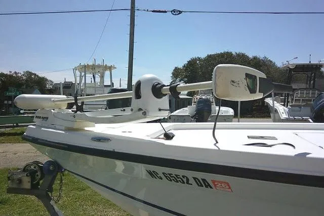 Slide: The Image of 2005 Century 2201 Bay Boat with trolling motor, parked on grass near marina. - 10