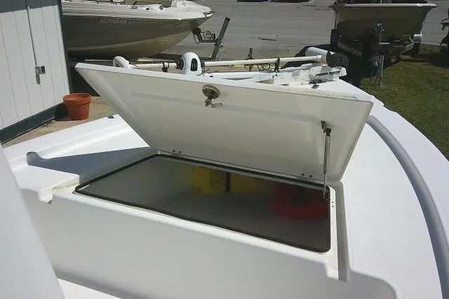 Slide: The Image of 2005 Century 2201 Bay Boat with open storage compartment on deck. - 12