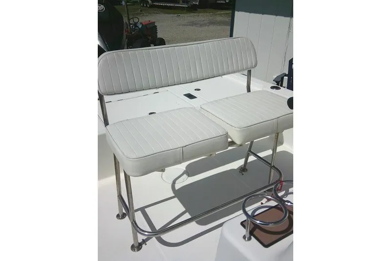 Slide: The Image of White cushioned seating on a 2005 Century 2201 Bay Boat, featuring metal frame support. - 18
