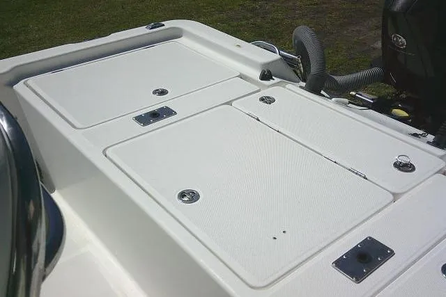 Slide: The Image of 2005 Century 2201 Bay Boat deck with storage compartments and engine hose. - 21
