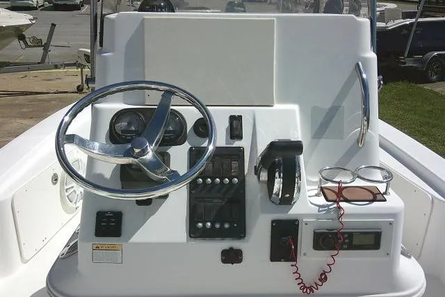 Slide: The Image of 2005 Century 2201 Bay Boat dashboard with steering wheel and controls. - 22