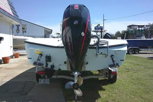 Slide: The Image of 2005 Century 2201 Bay Boat with outboard motor on trailer, parked outdoors. - 4