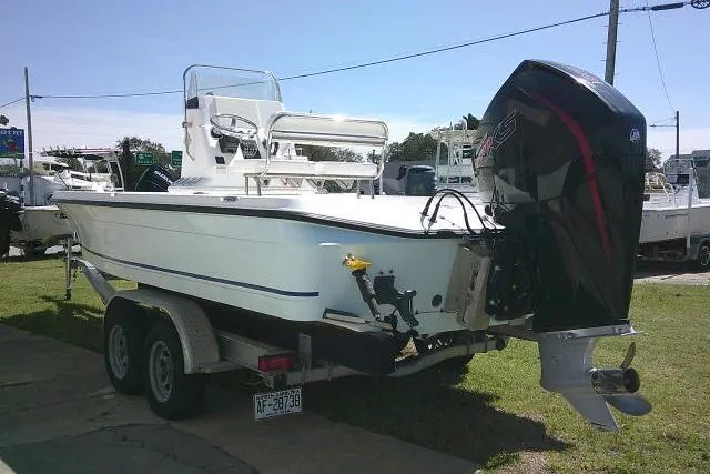 Slide: The Image of 2005 Century 2201 Bay Boat on trailer with outboard motor, parked outdoors. - 8