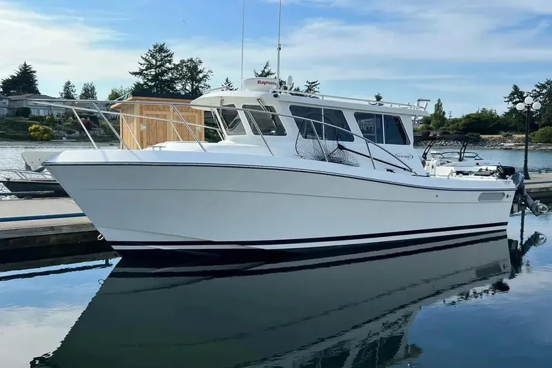 The Image of 2005 Ocean Sport Roamer #12 boat docked in a serene marina setting. - 0