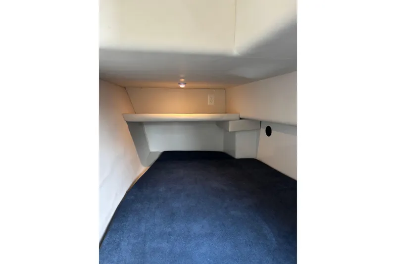 Slide: The Image of Interior cabin of 2005 Ocean Sport Roamer #12 with blue carpet and white walls. - 10