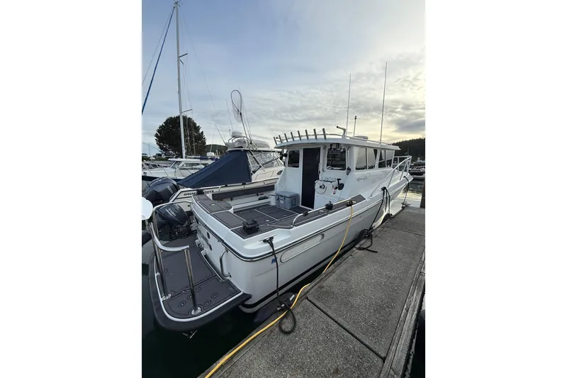 Slide: The Image of Ocean Sport Roamer #12, 2005 model, docked at marina under cloudy sky. - 16