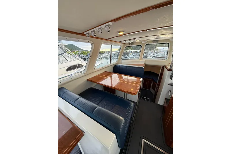 Slide: The Image of Interior of 2005 Ocean Sport Roamer #12 boat with seating and table. - 5