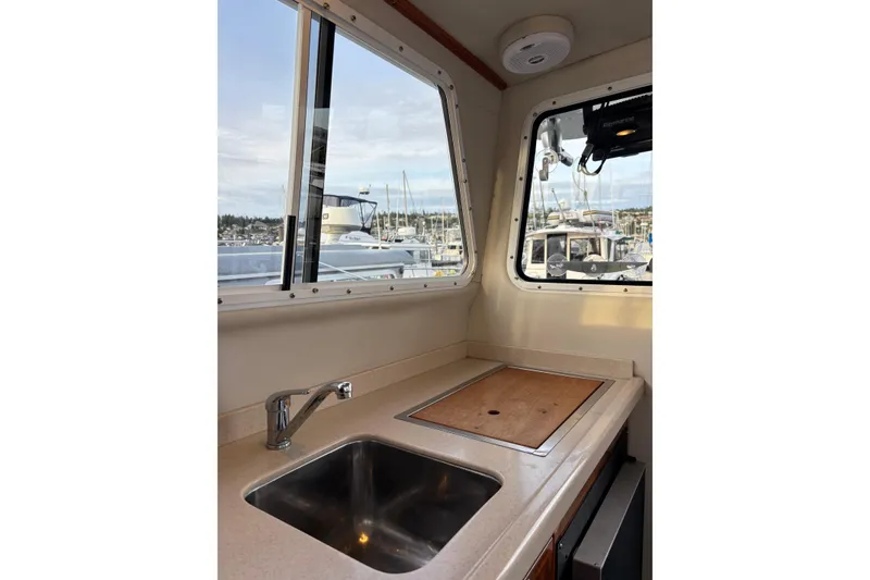 Slide: The Image of Interior view of 2005 Ocean Sport Roamer #12 boat kitchen with sink and window. - 7