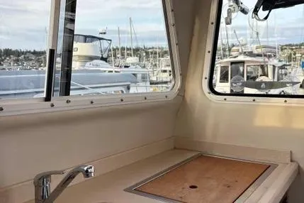 Slide: The Image of Interior view of 2005 Ocean Sport Roamer #12 boat with marina background. - 8