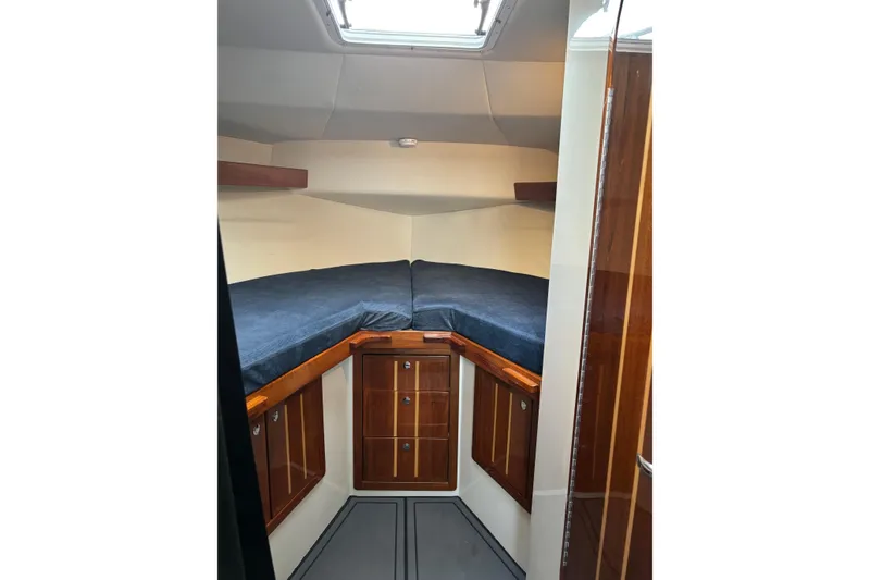Slide: The Image of 2005 Ocean Sport Roamer #12 cabin interior with wooden cabinetry and blue bedding. - 9