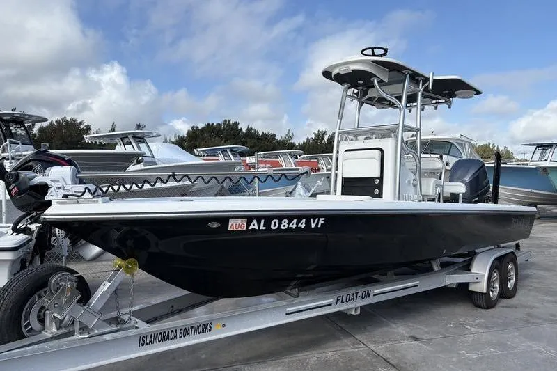 The Image of 2020 Islamorada 24 Morada boat on trailer, parked outdoors under cloudy sky. - 0