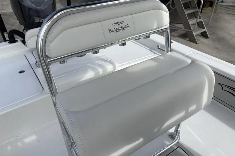Slide: The Image of 2020 Islamorada 24 Morada boat seat with sleek white upholstery and chrome accents. - 18