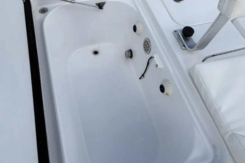 Slide: The Image of Livewell compartment in a 2020 Islamorada 24 Morada boat, featuring drainage and seating. - 30