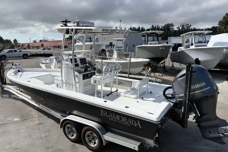 Slide: The Image of 2020 Islamorada 24 Morada boat with Yamaha engine on trailer in marina. - 1