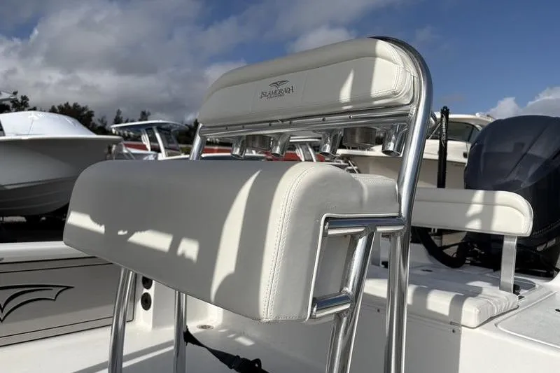 Slide: The Image of 2020 Islamorada 24 Morada boat seat with chrome frame under a blue sky. - 10