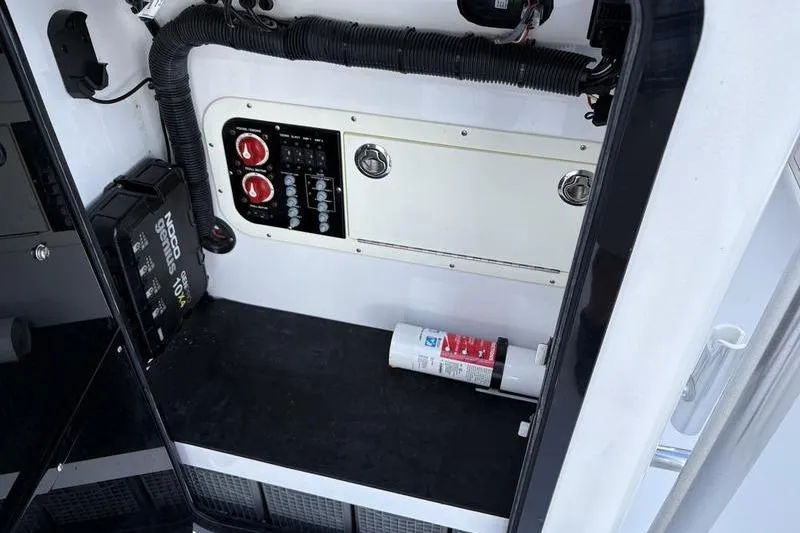Slide: The Image of Electrical panel and fire extinguisher inside 2020 Islamorada 24 Morada boat compartment. - 25