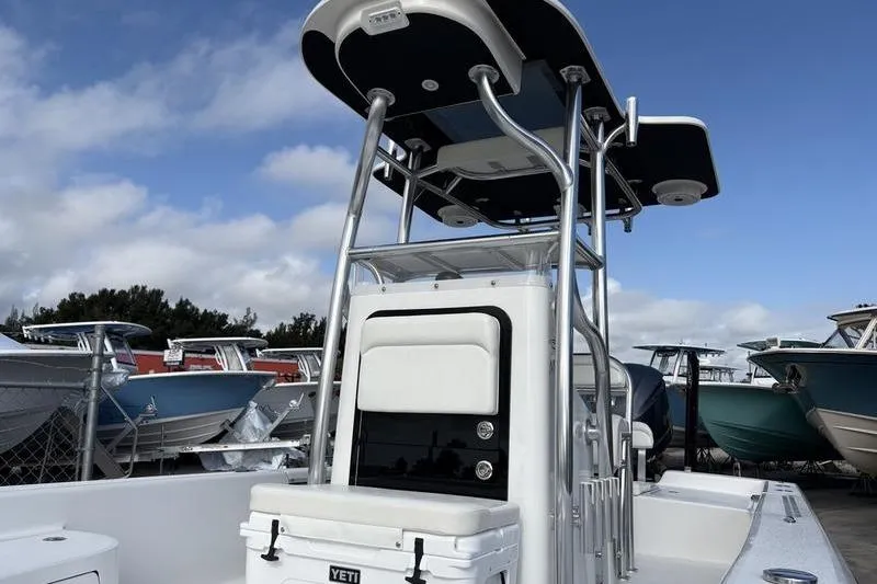 Slide: The Image of 2020 Islamorada 24 Morada boat with T-top and Yeti cooler, docked under blue sky. - 6