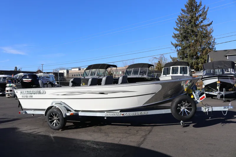 The Image of 2026 Alumaweld Super Vee 20 boat on trailer, parked outdoors under clear blue sky. - 0