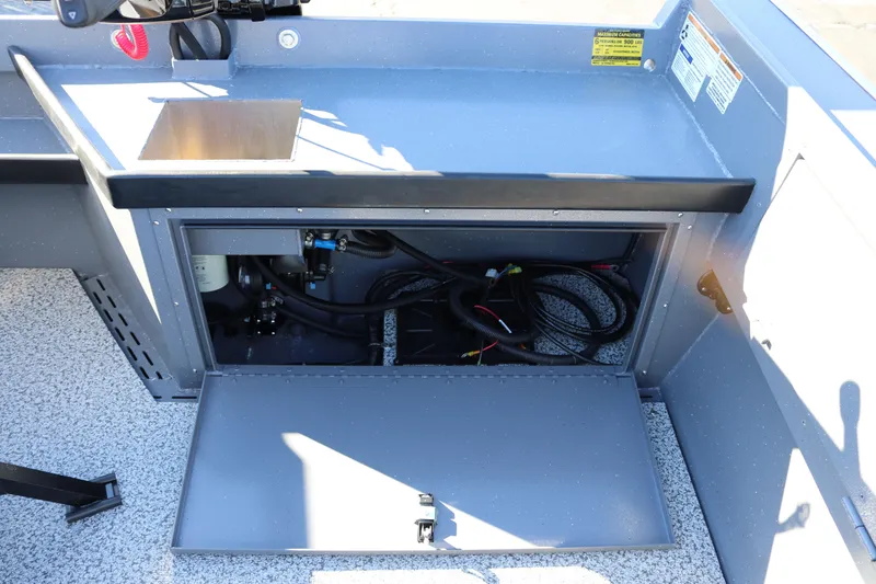 Slide: The Image of 2026 Alumaweld Super Vee 20 boat interior showing open storage compartment and wiring. - 11