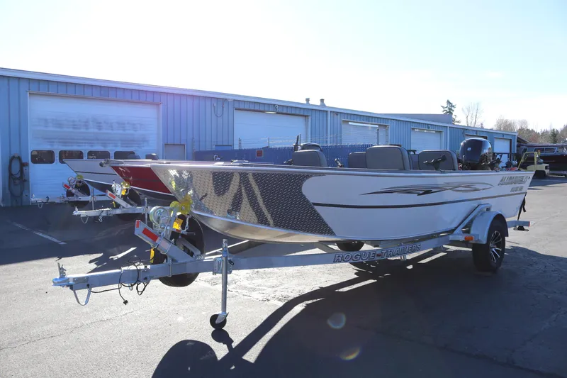 Slide: The Image of 2026 Alumaweld Super Vee 20 boat on trailer outside industrial building. - 5