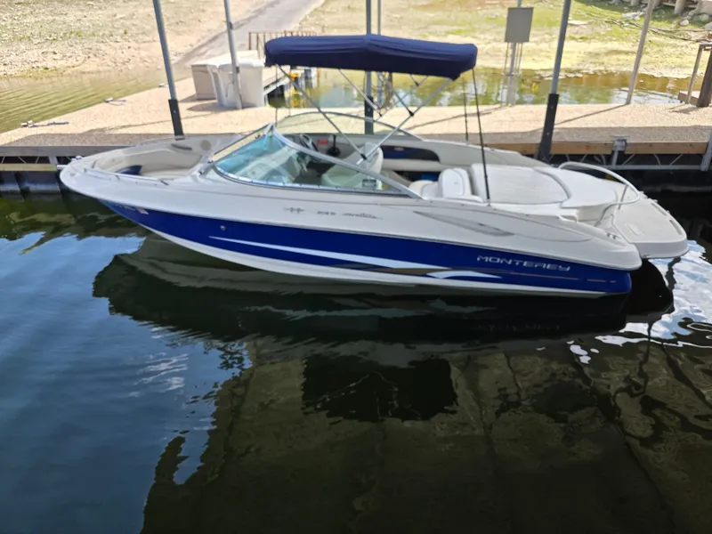 Slide: The Image of 2003 Monterey 208SI Montura boat in water, blue and white design. - 16