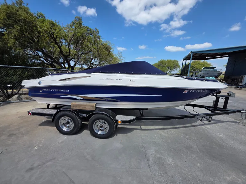 Slide: The Image of 2003 Monterey 208SI Montura boat on trailer, blue sky. - 2