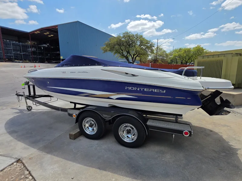Slide: The Image of 2003 Monterey 208SI Montura boat on trailer, blue hull. - 4