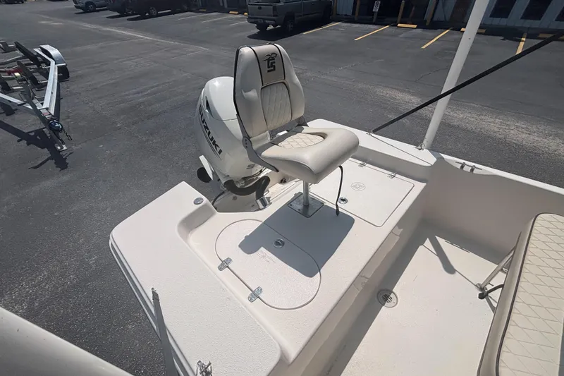 Slide: The Image of 2020 Carolina Skiff 192 JLS boat with Suzuki outboard motor and cushioned seating. - 11