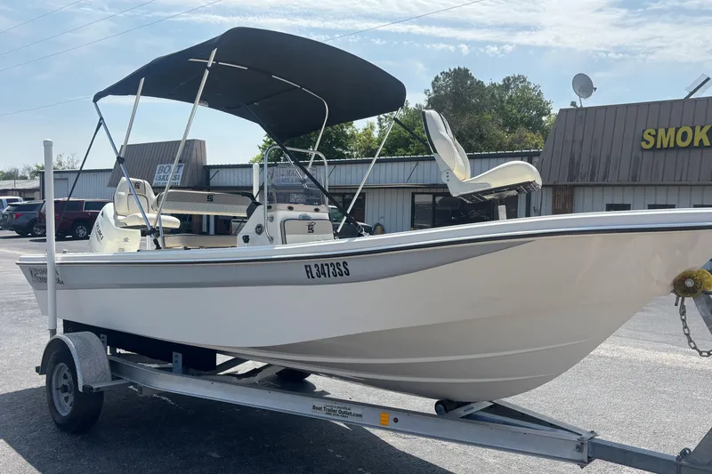 Slide: The Image of 2020 Carolina Skiff 192 JLS boat on trailer with canopy in parking lot. - 7