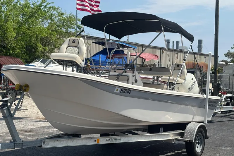 Slide: The Image of 2020 Carolina Skiff 192 JLS boat on trailer with canopy and American flag. - 9