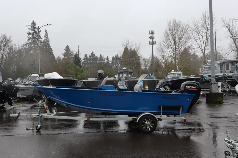 The Image of 2026 Smoker Craft Lazer 161 boat on trailer in a parking lot. - 1
