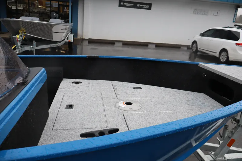 Slide: The Image of 2026 Smoker Craft Lazer 161 boat with blue exterior and spacious deck. - 11