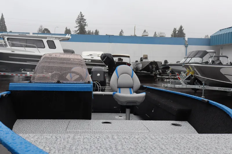 Slide: The Image of 2026 Smoker Craft Lazer 161 boat in showroom, featuring sleek design and comfortable seating. - 3