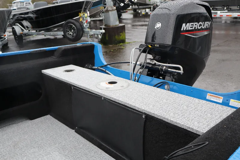 Slide: The Image of 2026 Smoker Craft Lazer 161 boat with Mercury outboard motor in a parking lot. - 6