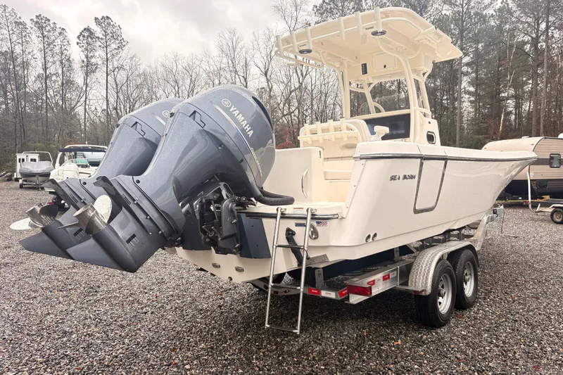 The Image of 2023 Sea Born LX26 Center Console boat with dual Yamaha engines on a trailer. - 0