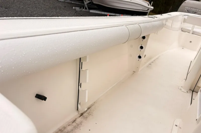 Slide: The Image of 2023 Sea Born LX26 Center Console boat interior with white seating and storage compartments. - 11