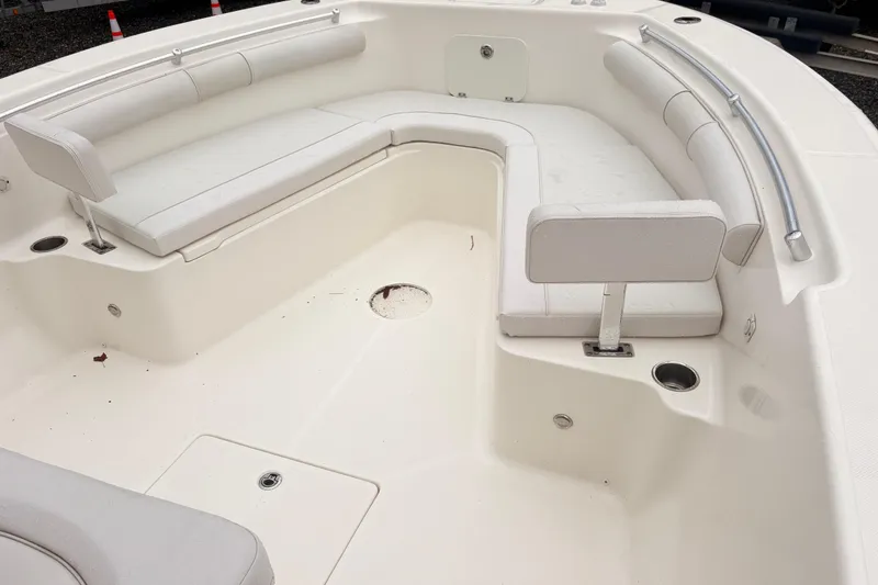 Slide: The Image of 2023 Sea Born LX26 Center Console boat interior with white seating and cup holders. - 14
