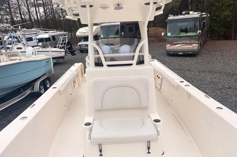 Slide: The Image of 2023 Sea Born LX26 Center Console boat in a parking lot with RVs and trailers. - 15