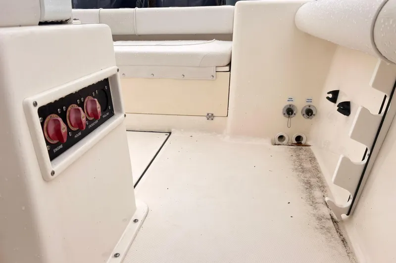 Slide: The Image of 2023 Sea Born LX26 Center Console interior with control panel and utility connections. - 18