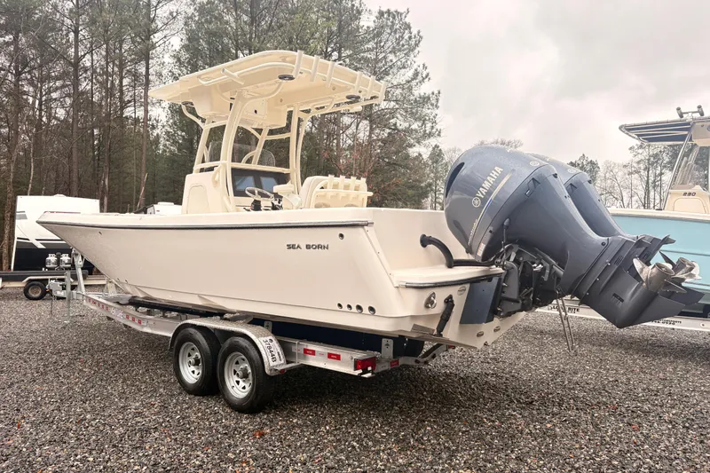 Slide: The Image of 2023 Sea Born LX26 Center Console boat on trailer, featuring Yamaha outboard motor. - 3