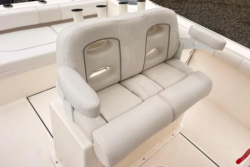 Slide: The Image of 2023 Sea Born LX26 Center Console boat seating with white cushioned bench and armrests. - 8
