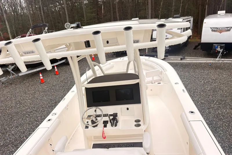 Slide: The Image of 2023 Sea Born LX26 Center Console boat with modern helm and rod holders. - 9
