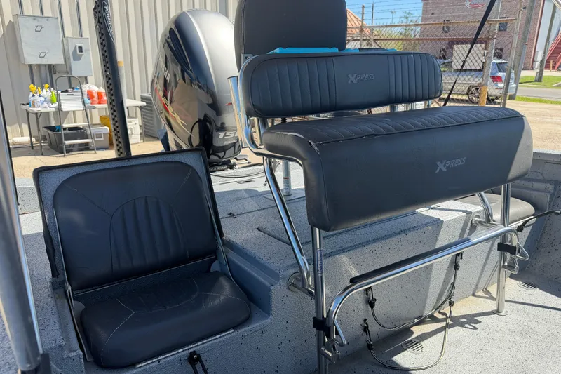 Slide: The Image of 2015 Xpress H22B Bay boat interior with seating and Yamaha outboard motor. - 11