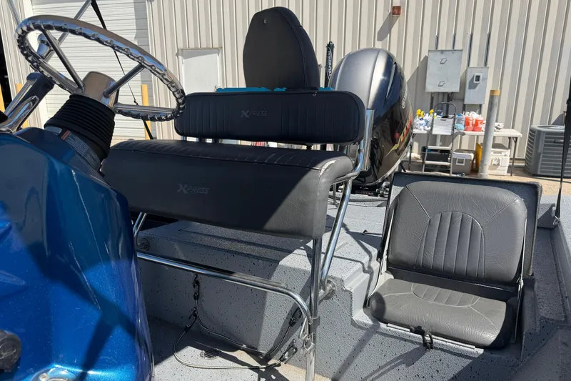 Slide: The Image of 2015 Xpress H22B Bay boat interior with steering wheel and seating. - 12