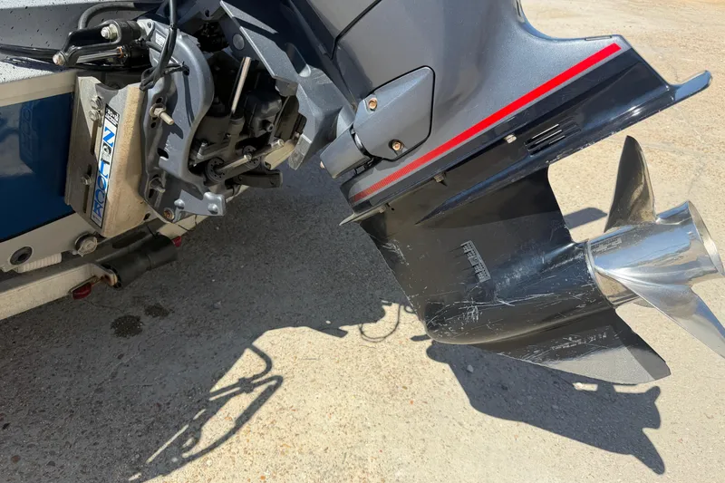 Slide: The Image of 2015 Xpress H22B Bay boat motor with propeller, showing wear and scratches. - 14