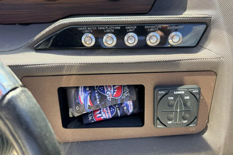 Slide: The Image of Dashboard controls of a 2016 Cobalt R7 boat with light switches and Lenco trim tab. - 11