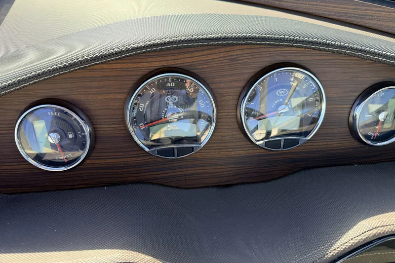Slide: The Image of Dashboard gauges of a 2016 Cobalt R7 boat with wood finish. - 12