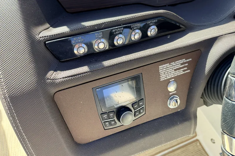 Slide: The Image of Control panel of a 2016 Cobalt R7 boat with switches and display. - 13